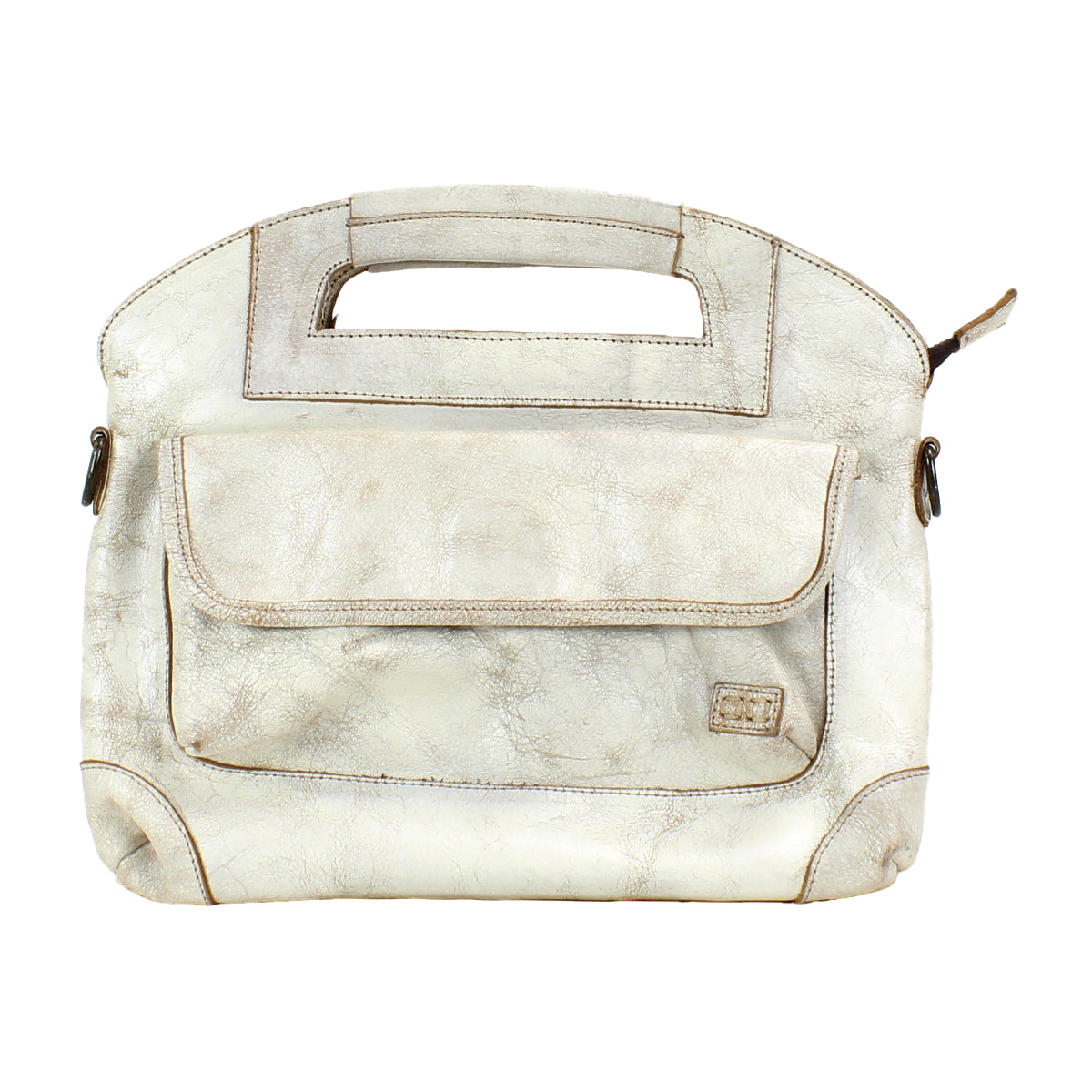 The Bed|Stü Greenway is a beige full-grain leather handbag featuring a rectangular cutout handle, a front pocket with flap, and visible stitching. Shown against a white background, this versatile bag includes a detachable crossbody strap for hands-free convenience.