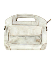The Bed|Stü Greenway is a beige full-grain leather handbag featuring a rectangular cutout handle, a front pocket with flap, and visible stitching. Shown against a white background, this versatile bag includes a detachable crossbody strap for hands-free convenience.