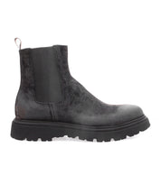 Introducing the Grit by Bed|Stü—a men’s Chelsea boot crafted from black oiled suede, featuring elastic side panels, a heel pull tab, and a chunky rubber sole.