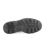 Bed|Stü’s Grit: a black rubber sole featuring deep, rugged treads and triangular patterns—ideal for Italian handcrafted boots—shown from the bottom on a white background.