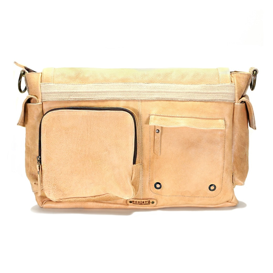 The Hawkeye II by Bed|Stü is a rugged tan leather messenger bag featuring two front pockets, silver zippers, adjustable side straps, and a padded laptop sleeve inside, displayed against a white background.