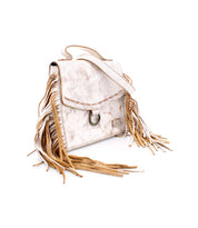 Bed|Stü's Hidden handbag in white features a structured silhouette crafted from soft leather, with brown fringe details, a flap closure, metal ring accent, and a shoulder strap, displayed on a white background.