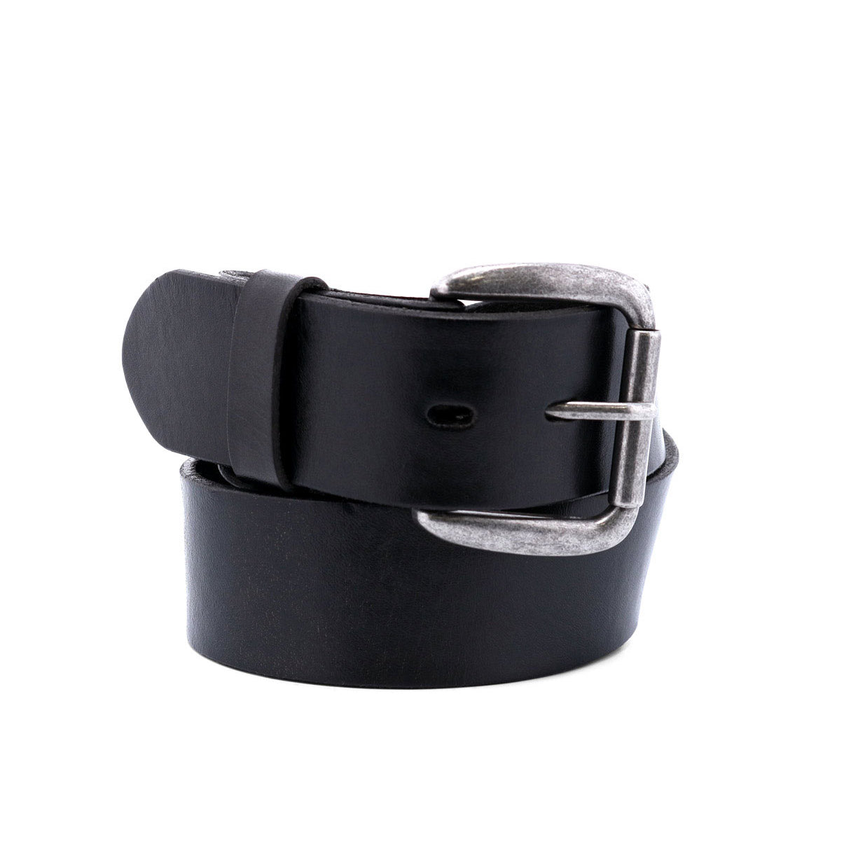 The Bed|Stü Hobo belt, featuring a black leather strap and a sleek silver metal buckle, is rolled up and standing upright against a white background—an ideal accessory to elevate your everyday style.