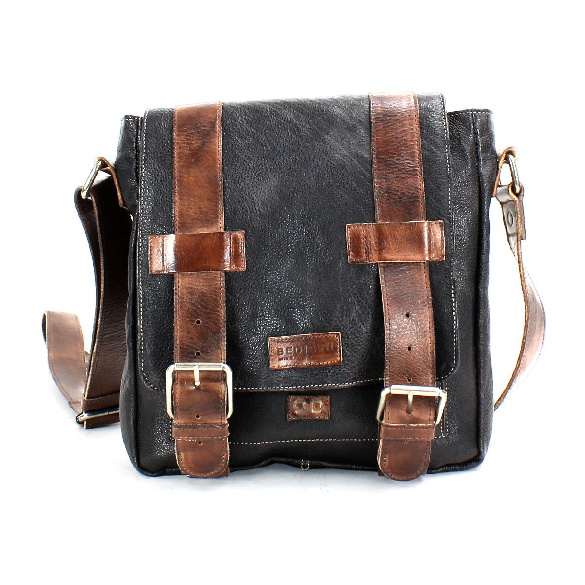 Introducing Hue by Bed|Stü—a black leather messenger bag accented with brown leather straps and brass buckles, designed with an adjustable crossbody strap and a secure front flap closure. Perfect for seamlessly transitioning from work to weekend.