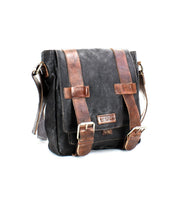 Introducing the Hue messenger bag by Bed|Stü—a black leather bag featuring rich brown straps, metal buckles, and an adjustable crossbody strap. Perfect for carrying your essentials from work to weekend, it's showcased against a crisp white background.