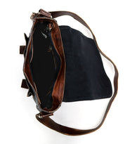 The Bed|Stü Hue black messenger bag, shown open and empty against a white background, features a brown strap, brown inner lining, and an adjustable crossbody strap—perfect for your work-to-weekend needs.