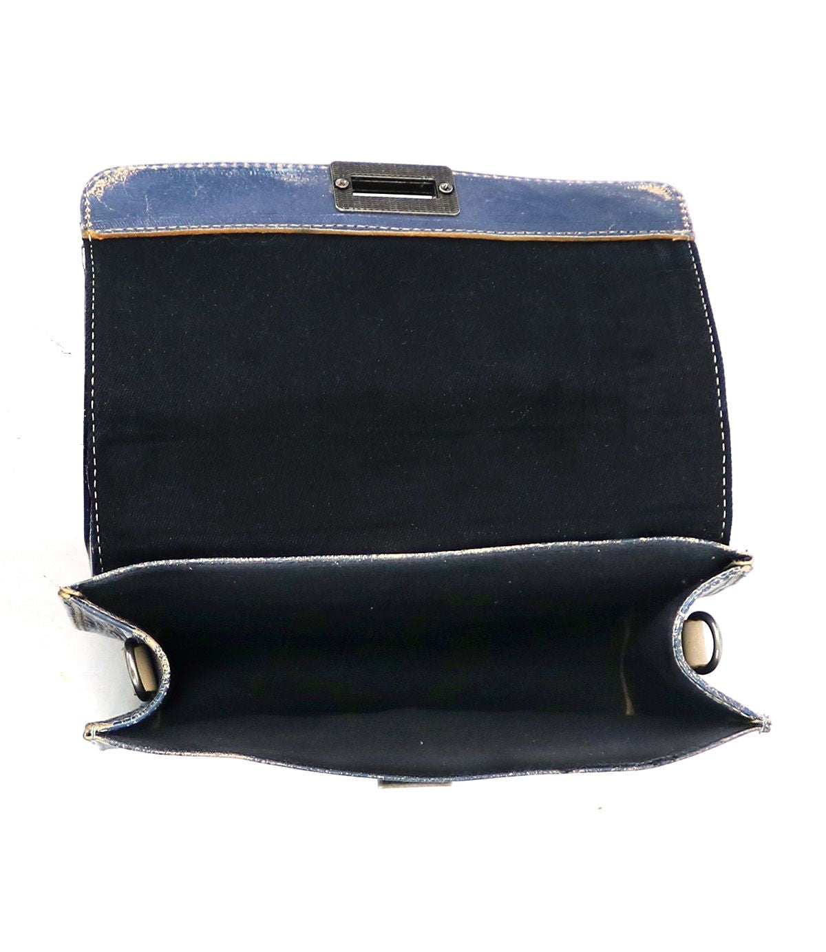 The Improv handbag by Bed|Stü is displayed open and empty against a white background, showcasing its blue fabric exterior, black interior, and a convenient top handle for easy carrying.