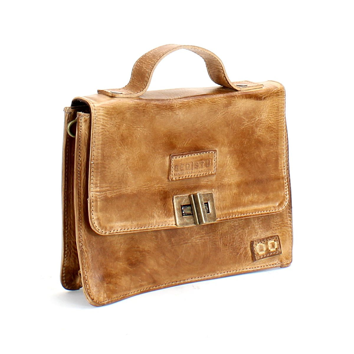 The Improv satchel by Bed|Stü—a light brown leather bag featuring a top handle, front flap, and metal clasp—is displayed against a white background.