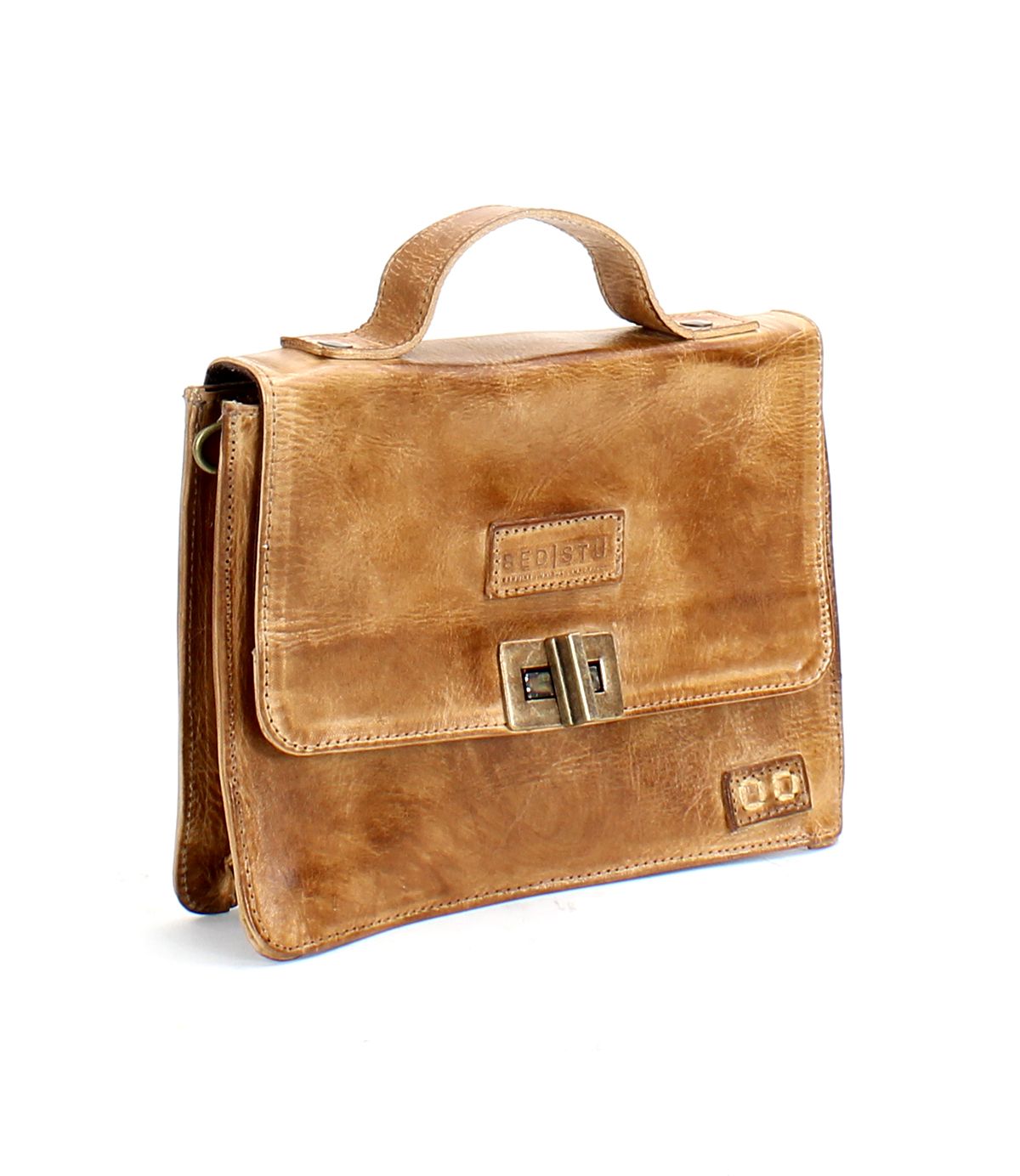 The Improv satchel by Bed|Stü—a light brown leather bag featuring a top handle, front flap, and metal clasp—is displayed against a white background.