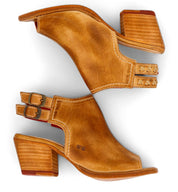 A pair of Ireni tan leather peep toe heeled sandals by Bed|Stü, featuring double buckle straps, stacked wooden heels, and a cushioned footbed for all-day comfort—your perfect everyday heel—are laid side by side on a white background.