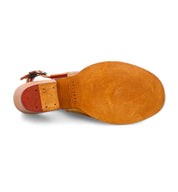 The image shows the bottom view of the Ireni sandal by Bed|Stü, featuring tan leather with a red heel section and the brand name "Bed|Stü" embossed in the arch area. This everyday style includes a cushioned footbed for added comfort, making it ideal for all-day wear.