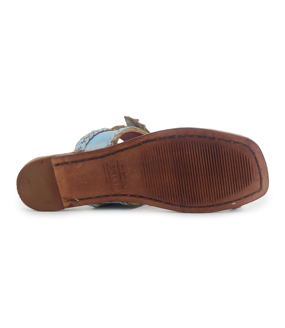 The image shows the bottom view of the Bed|Stü Isobel sandal, featuring a well-worn leather sole in brown with visible stitching around the edge. Slightly grooved tread and scuffing on the heel highlight its status as a beloved summer staple.