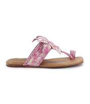 The Isobel sandal by Bed|Stü features a flat wooden sole, pink marbled leather straps, and a decorative bow on top, bringing a charming touch to your summer wardrobe.