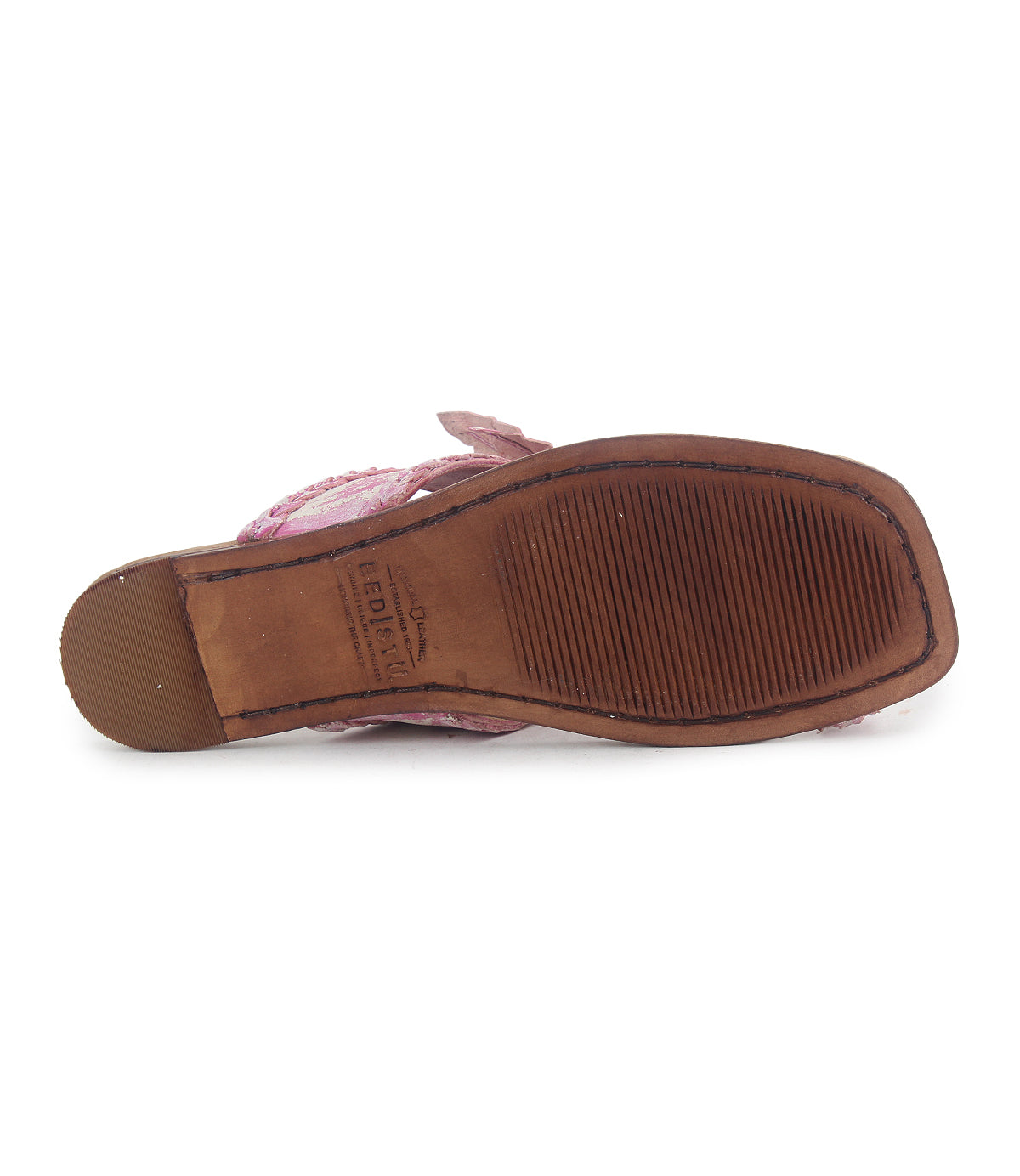 A close-up view of the bottom of the Bed|Stü Isobel sandal, featuring a textured rubber sole and pink braided straps on the upper side—perfect for completing your summer looks.