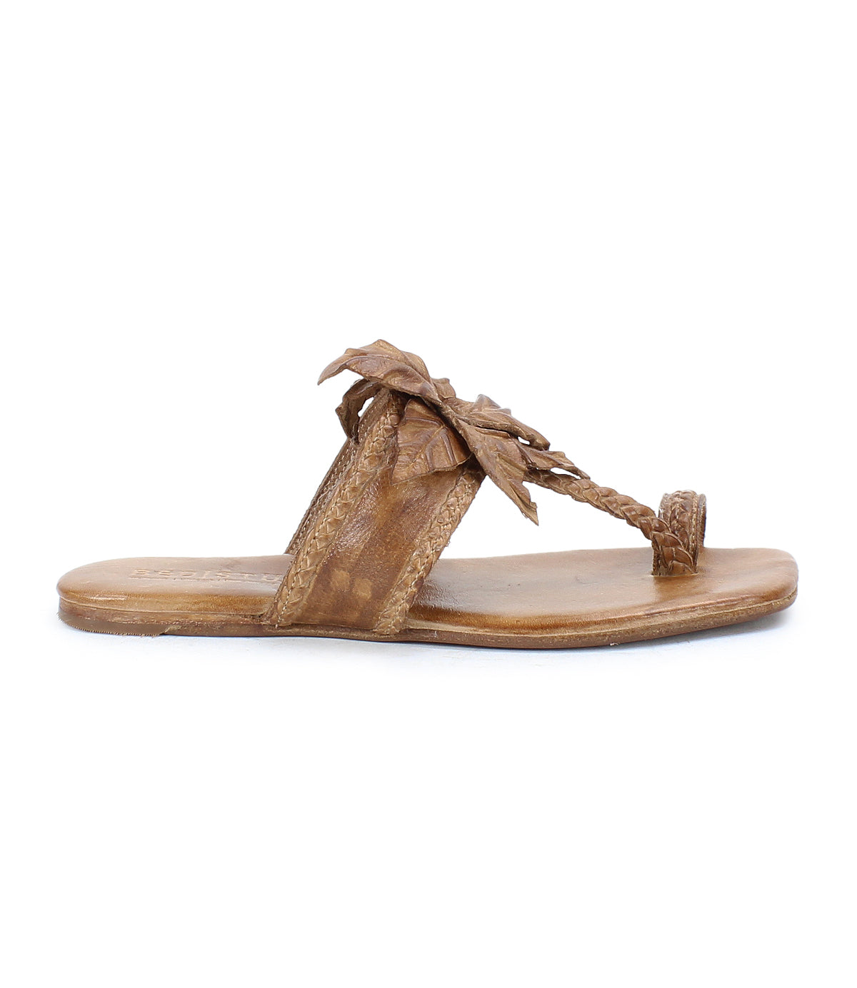 Step out in effortless summer style with the Isobel sandal from Bed|Stü—a brown leather flat featuring a braided thong strap and a detailed leaf accent on the upper.