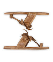 The Isobel sandals by Bed|Stü are flat brown leather sandals featuring braided straps and decorative bows, perfect for completing your favorite summer looks. Shown from the side on a white background.