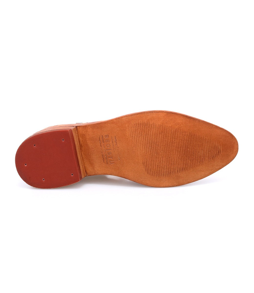 Close-up of the sole of the Bed|Stü Jenny brown leather dress shoe, highlighting a textured rubber heel and forefoot with fine grooves for improved grip. This shoe also features a cushioned insole for enhanced all-day comfort.
