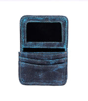A worn blue Jeor leather card wallet by Bed|Stü is open to reveal two credit card slots and a transparent ID window.