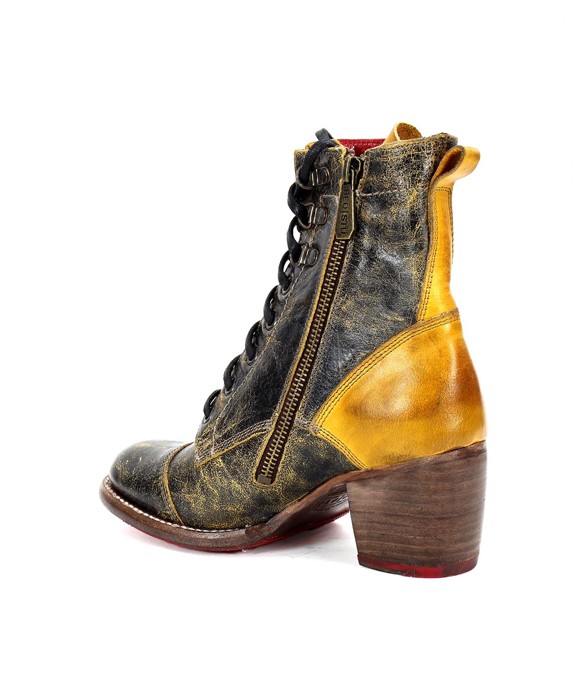 The Bed|Stü Judgement boot is a worn, leather lace-up design featuring a medium block heel, cap toe, side zipper, and a distressed yellow and black leather finish, shown against a white background.