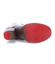 A single Bed|Stü Judgement dress shoe is displayed sole-up, showcasing a red rubber outsole with visible stitching and embossed Bed|Stü branding, a stacked heel, and classic cap toe styling.