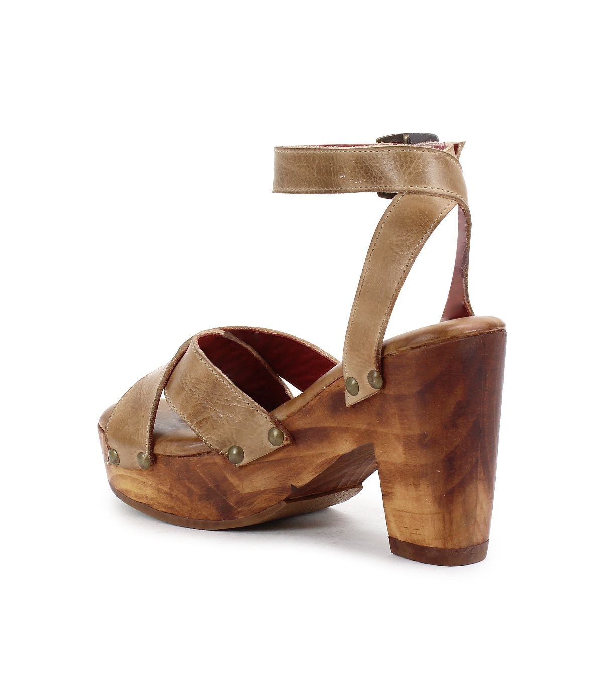 The Bed|Stü Kalah is a tan leather strappy sandal featuring an adjustable ankle strap, a sustainably sourced wooden sole, and a chunky high heel, shown from the side and slightly behind on a white background.
