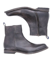 The Bed|Stü Kaldi is a pair of dark brown leather ankle boots featuring side zippers and pull tabs, displayed from the side and bottom against a white background; these classic boots effortlessly blend style with practicality.