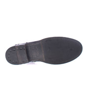 The image shows the underside of the Bed|Stü Kaldi black leather dress shoe, featuring visible stitching, a nailed heel, and embossed branding on the sole—details that reflect the craftsmanship characteristic of a classic or refined leather boot.
