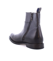 The Kaldi by Bed|Stü is a black leather ankle boot featuring a side zipper, back pull tab, round toe, and low heel—this timeless classic is shown on a white background.