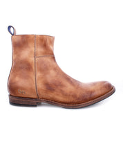The Bed|Stü Kaldi is a brown leather ankle boot featuring a low heel, side stitching detail, a back pull tab, and a slightly worn finish—shown here in a left side profile view.