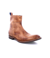 The Kaldi ankle boot by Bed|Stü, crafted in light brown leather with a low heel and rounded toe, is displayed at a three-quarter angle against a white background.