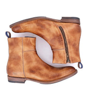 A pair of Kaldi tan leather ankle boots by Bed|Stü, featuring side zippers and blue heel loops, are displayed side by side on a white background—these classic boots effortlessly combine style and comfort.
