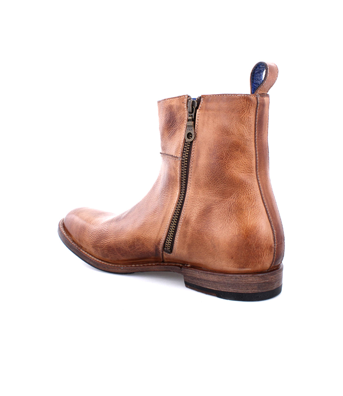 The Bed|Stü Kaldi is a brown leather ankle boot featuring a side zipper, low stacked heel, and visible stitching, photographed on a white background.