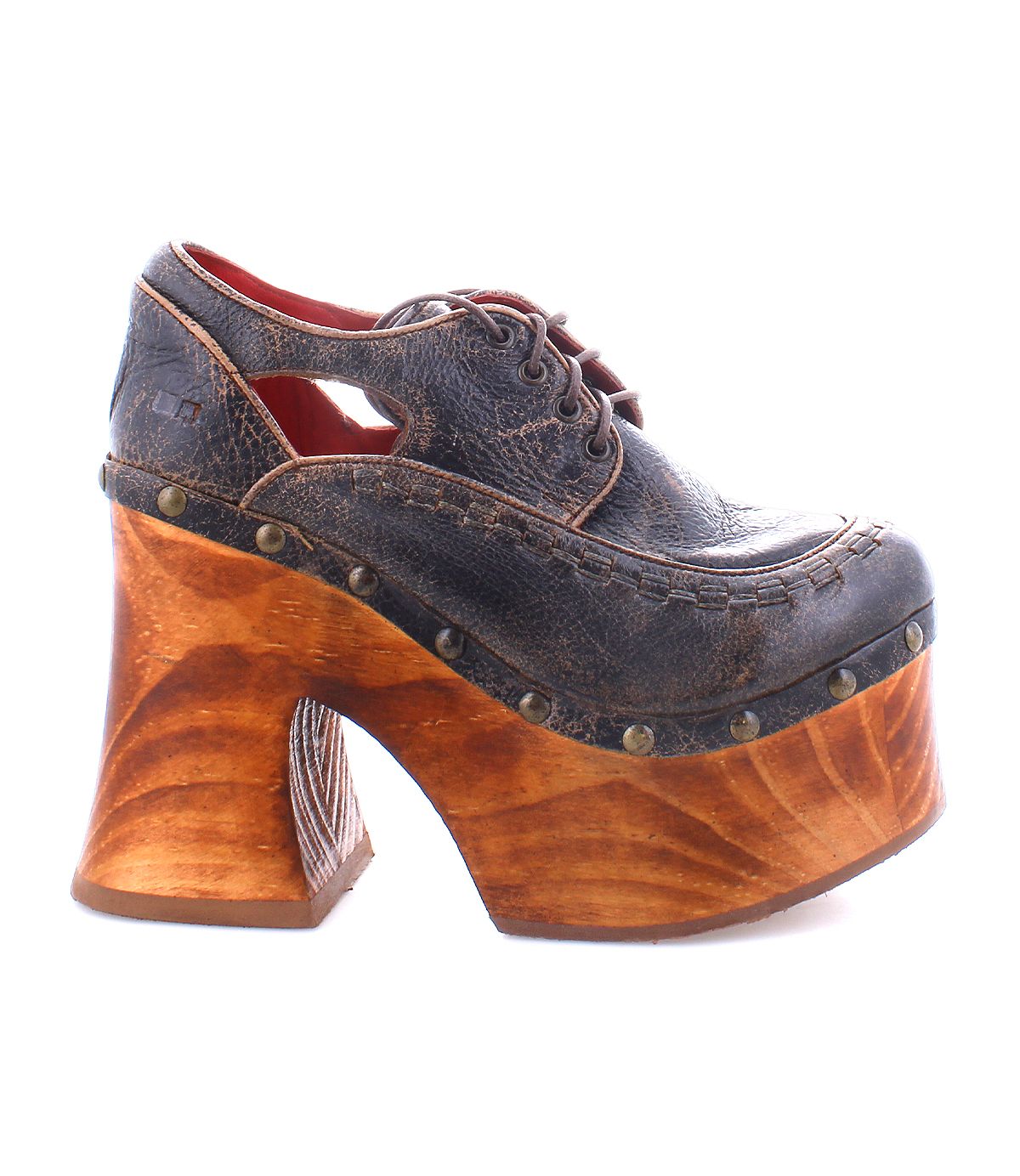 Experience the Bed|Stü Karaoke: a vintage-inspired platform shoe featuring a dark leather upper, decorative stitching, brass studs, lace-up detail, and a chunky sculpted wooden heel reminiscent of classic 70s style.