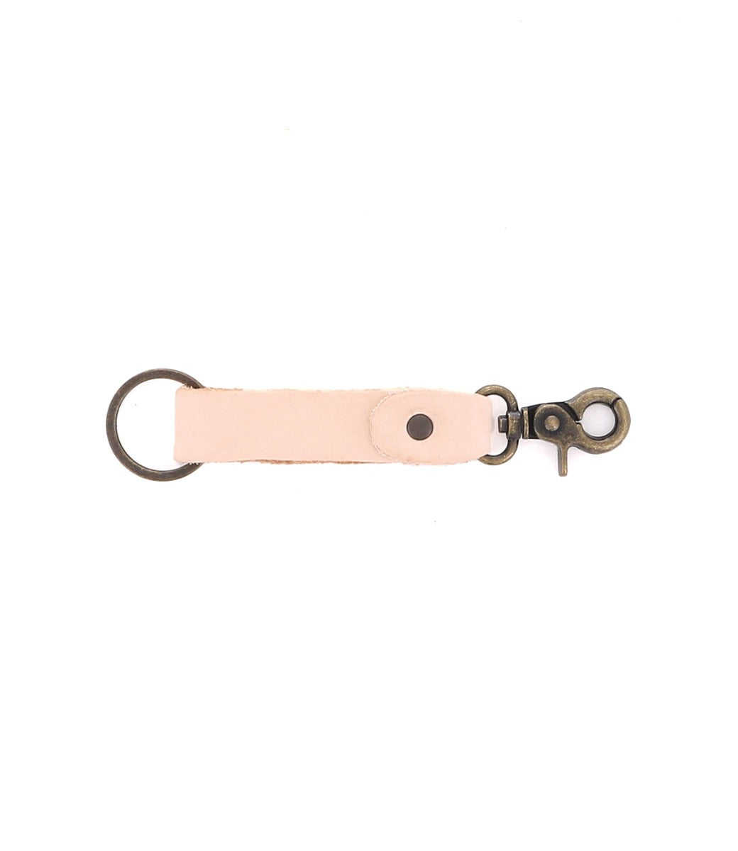 The Bed|Stü Keygrab is a full grain leather key organizer featuring a sturdy metal swivel clip on one end and a metal key ring on the other, shown isolated on a white background.