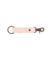 The Bed|Stü Keygrab is a full grain leather key organizer featuring a sturdy metal swivel clip on one end and a metal key ring on the other, shown isolated on a white background.