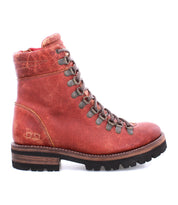 A single Bed|Stü Khya red leather lace-up boot featuring metal eyelets, a thick dark treaded outsole, and visible signs of wear on the heel and ankle areas.