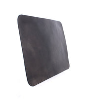 The Bed|Stü Launcher Mouse Pad, crafted from black leather in a plain rectangular design with rounded corners, is displayed against a white background, offering an elegant and sophisticated accessory for any workspace.