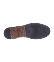 Bottom view of the Bed|Stü Lincoln II dress shoe, showcasing a leather and rubber sole with visible stitching and branding near the heel, and featuring an apron toe design commonly seen in men's boots.