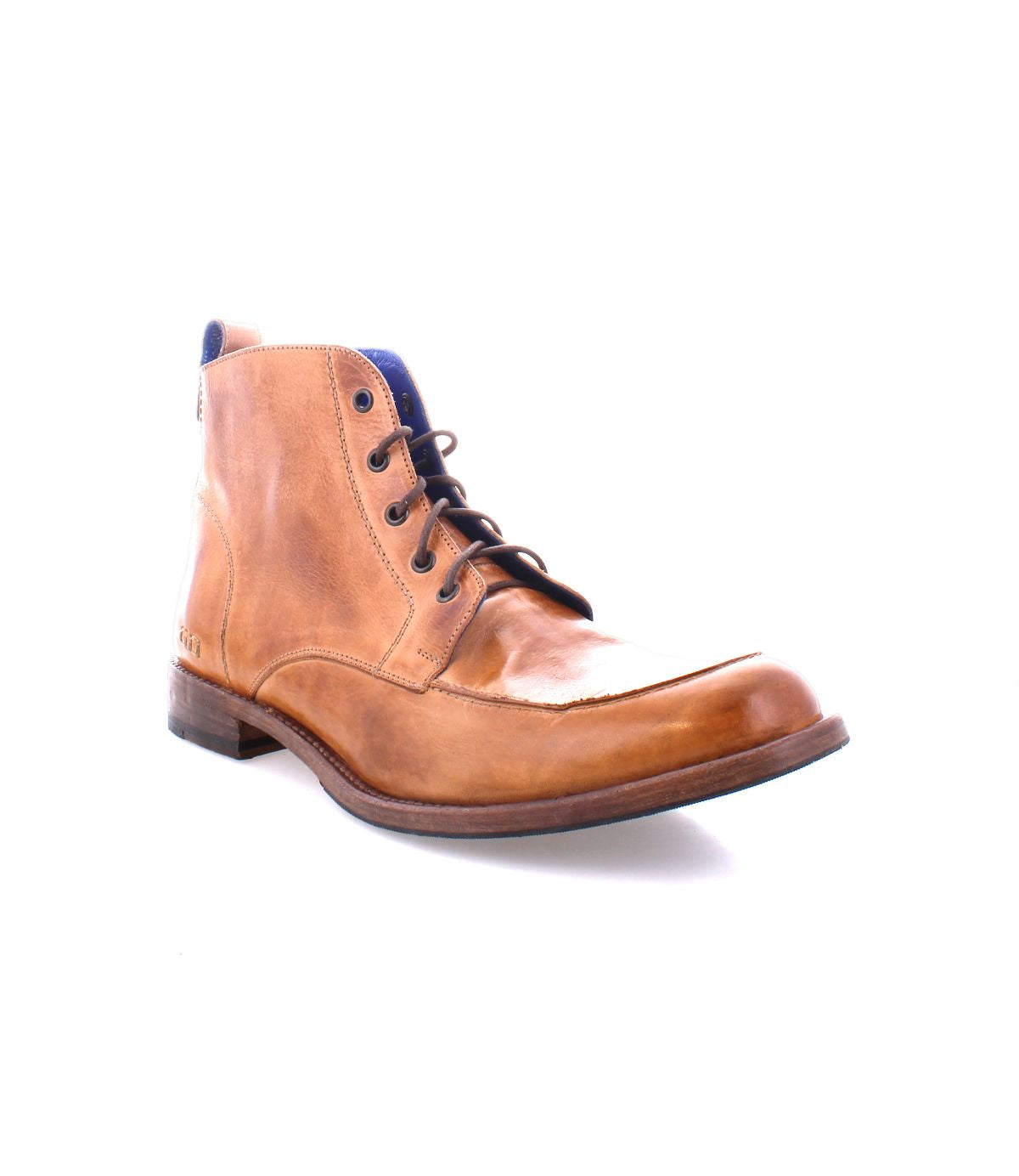 The Bed|Stü Lincoln II is a brown leather lace-up ankle boot featuring an apron toe, low heel, dark sole, and blue inner lining, displayed against a white background. This stylish men's boot effortlessly combines work-boot durability with modern design.