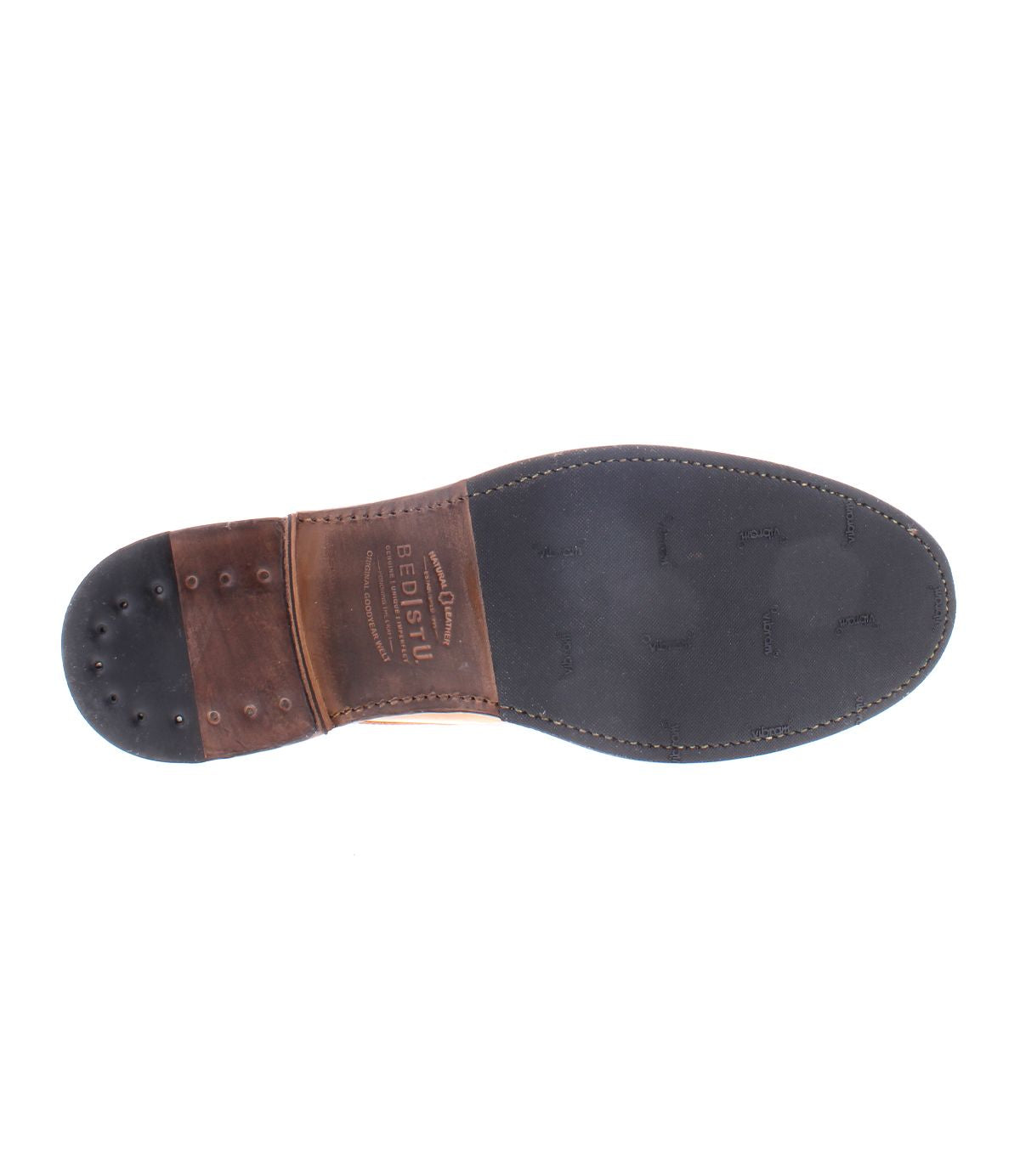 The Lincoln II by Bed|Stü features a sole crafted from black leather with a contrasting brown heel, visible stitching, and small metal tacks on the heel section—highlighting durable craftsmanship reminiscent of quality found in classic men's boots.