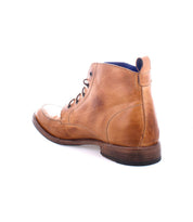 The Bed|Stü Lincoln II is a men's brown leather lace-up boot featuring an apron toe and a wooden sole, shown from the back against a white background.