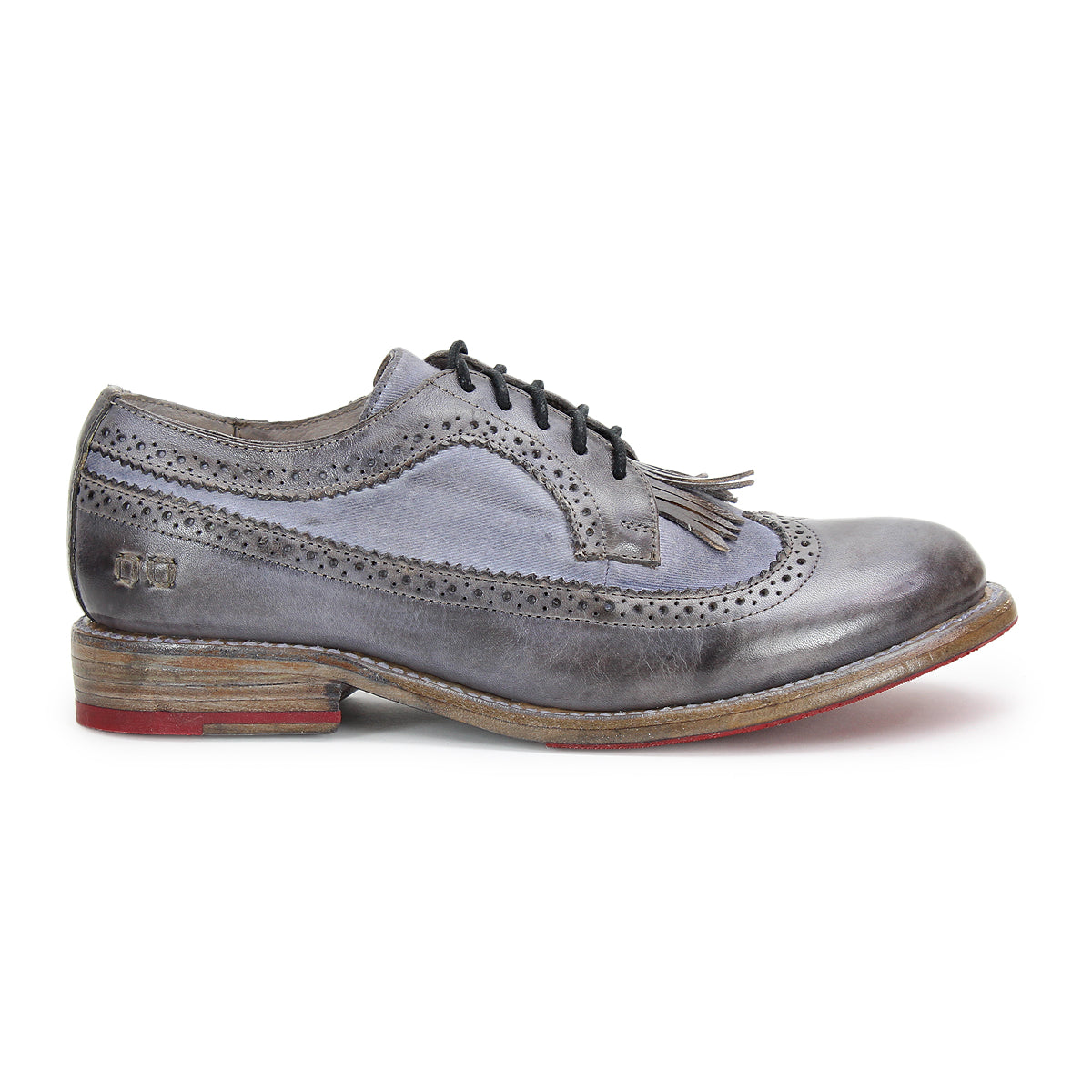 Gray leather Wingtip Toe oxford shoe by Bed|Stü, model Lita K, featuring black laces, elegant brogue details, and a low wooden sole with a red accent on the heel, shown in profile on a white background.