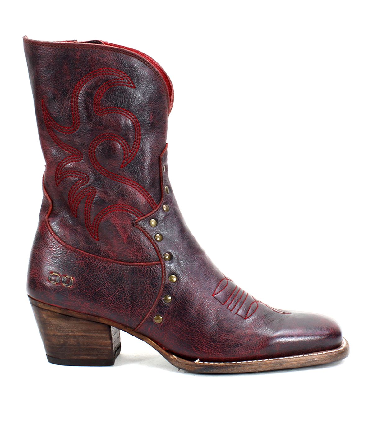 A single Bed|Stü Locate Western boot in dark red leather, featuring decorative flame stitching, metal studs, a low wooden heel, a side zipper, and a slightly worn look.