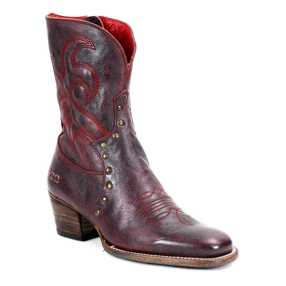 The Locate by Bed|Stü is a single dark red leather Western boot featuring decorative flame stitching, metal studs, a stacked wooden heel, a slightly pointed toe, and a convenient side zipper.