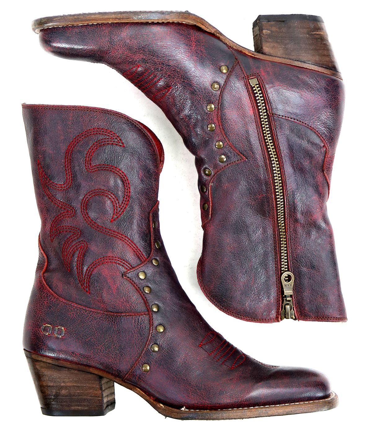 A pair of worn, reddish-brown "Locate" leather Western boots by Bed|Stü, featuring side zippers, decorative flame stitching, metal studs, and stacked wooden heels, shown from the side on a white background.