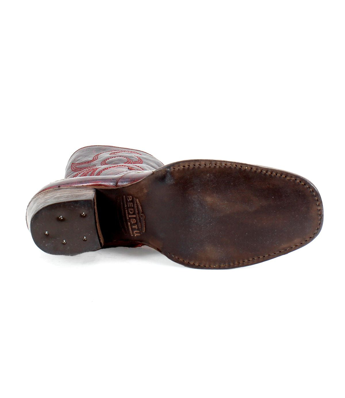 The image shows the sole of the Bed|Stü Locate brown leather Western boot, featuring visible stitching and metal tacks on the heel.