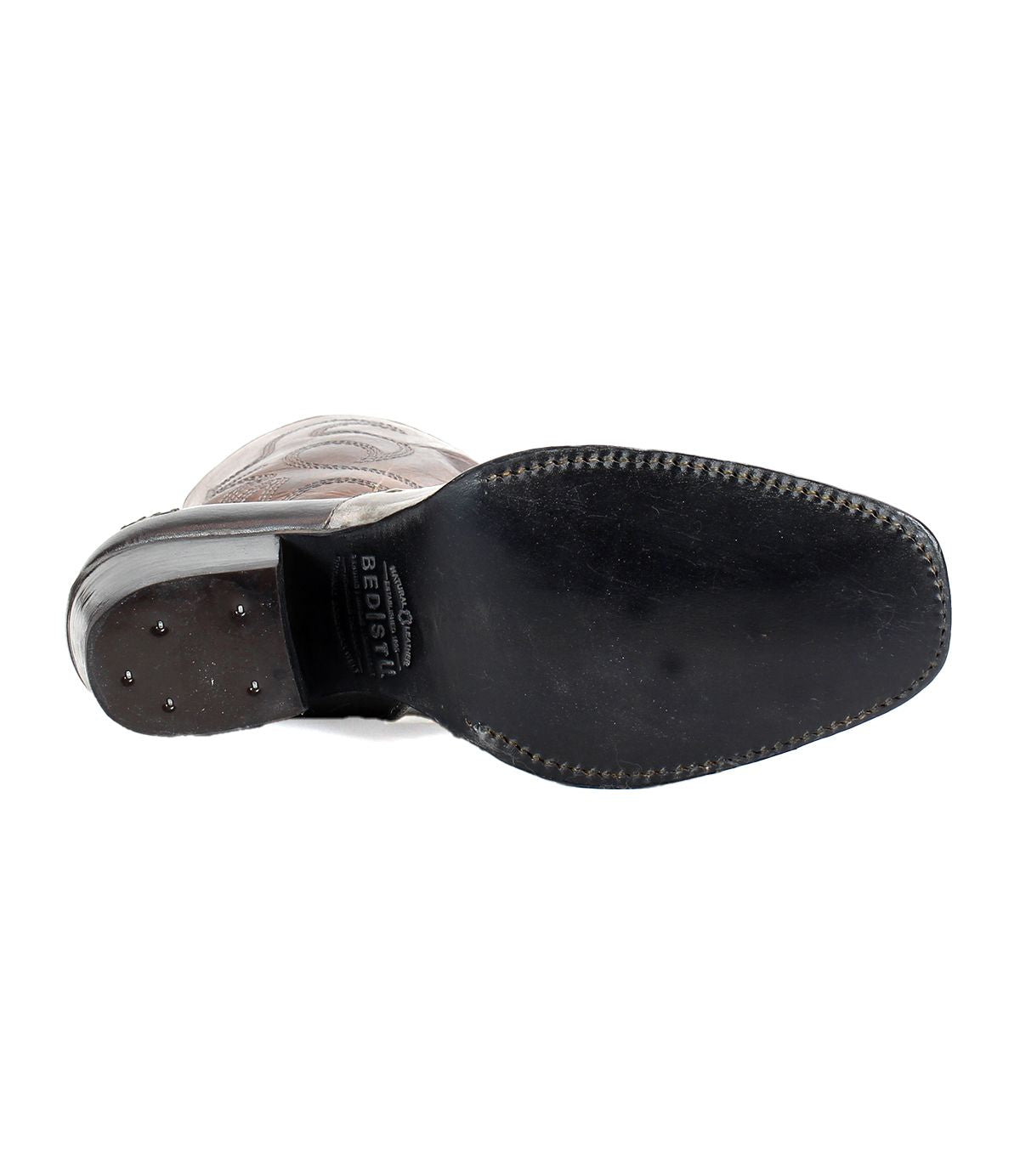Bottom view of the Bed|Stü Locate black leather dress shoe, featuring stitching around the sole and small metal studs near the heel, echoing flame stitching details often seen on Western boots.