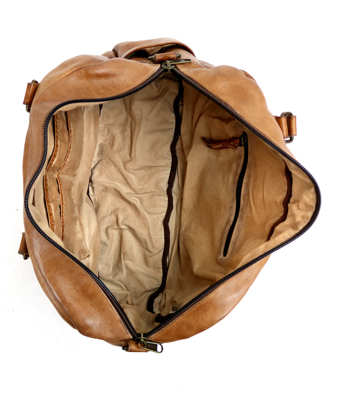 Top-down view of the Bed|Stü Luke travel bag in brown vegetable-tanned leather, featuring a beige fabric lining, an inner zippered pocket, and open side pockets.