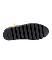 The image shows the bottom view of the Bed|Stü Lydyi shoe, featuring a black sole with deep, horizontal ridges and a textured heel area—details that suggest this is a leather ankle boot with a sturdy platform outsole.