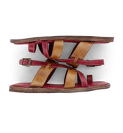 A pair of Bed|Stü Manati II sandals, featuring handcrafted red and tan leather straps, brown soles, and a buckle, displayed side by side on a white background.